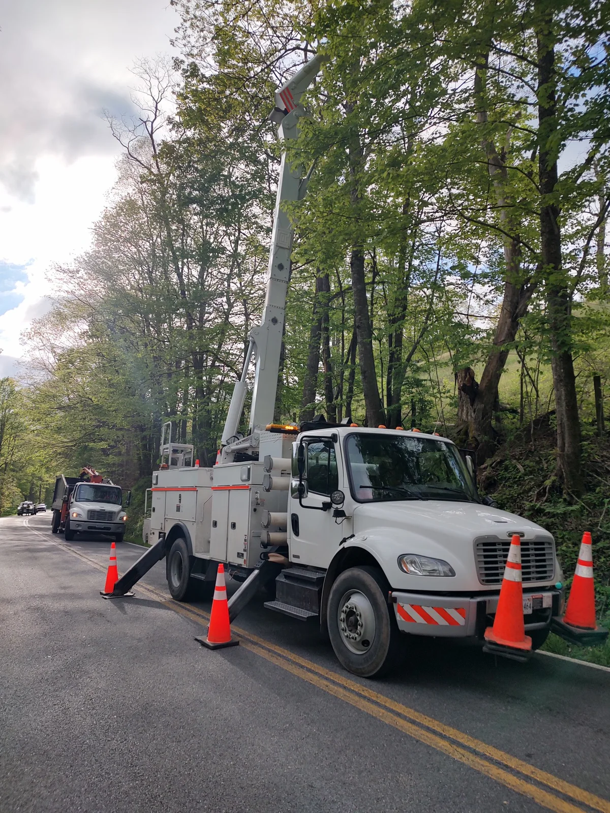 Bucket truck and support truck staged roadside